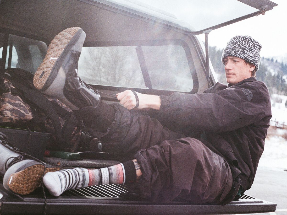 Spencer Shubert putting on Stance snow socks